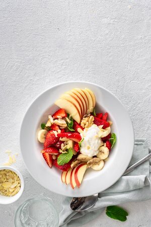 Fresh fruit salad on a white background top view. Healthy food plate copy spaceの写真素材