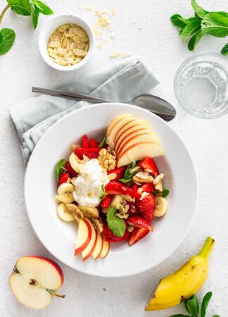 Fresh fruit salad on a white background top view. Healthy food plateの写真素材