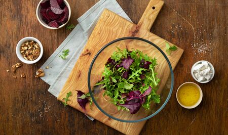 Raw ingredients for cooking fresh salad on wooden table top viewの写真素材