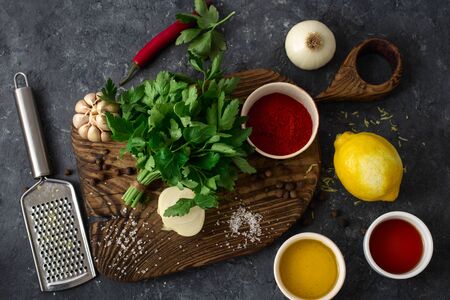 Ingredients for cooking Argentinian green Chimichurri or Chimmichurri salsa or sauce made of parsley, chili pepper, olive oil, garlic and vinegarの写真素材