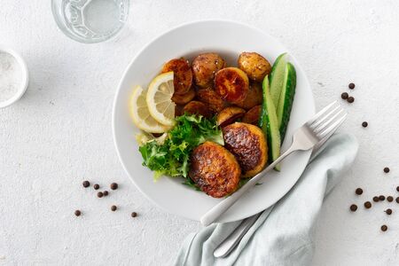 Lunch plate with healthy food Fresh vegetarian cutlets with new potatoes and salad on a white background top viewの写真素材