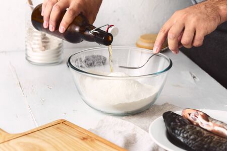 Man cooking French beer batter for fish. Preparation tasty and healthy foodの写真素材