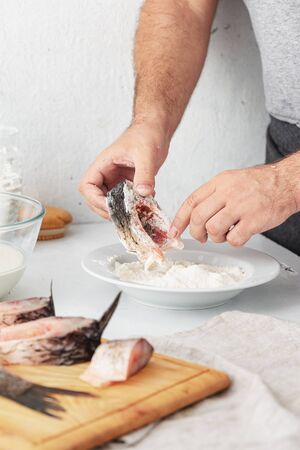 Man prepares carp river fish. Cooking healthy and diet foodの写真素材