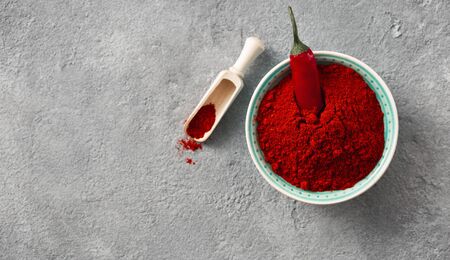 Chili pepper powder on concrete background with copy space top viewの写真素材