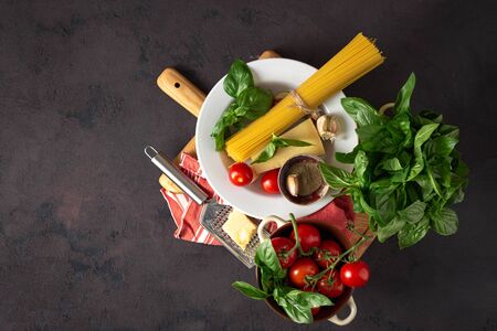 Recipe cooking Italian pasta. Raw ingredients for cooking on a dark backgroundの写真素材