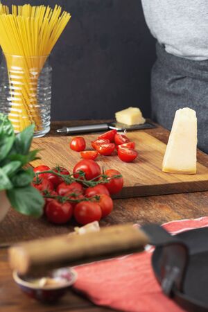 Raw pasta with ingredients for cooking Italian spaghetti in the kitchenの写真素材