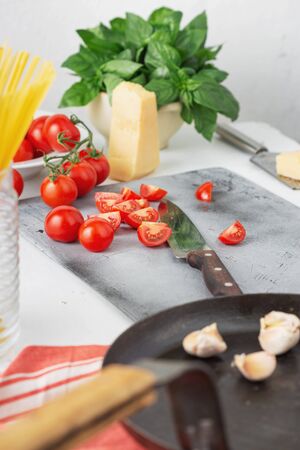 Recipe cooking Italian pasta. Raw pasta with ingredients for cooking in the kitchenの写真素材