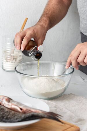Man prepares French beer batter for fish. Cooking tasty and healthy foodの写真素材
