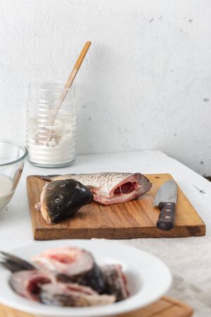 Cooking carp steaks in home kitchen. Preparing healthy and diet foodの写真素材