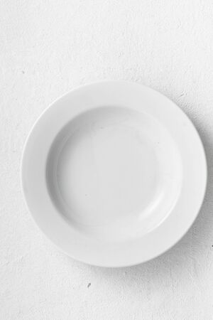 Empty white round plate on a white  top viewの写真素材