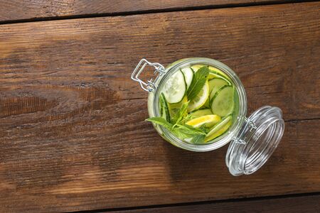 Detox drink cucumber water on wooden teble with copy space top view. Dieting conceptの写真素材