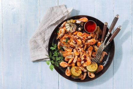 Fresh fried prawns on a blue wooden background top viewの写真素材