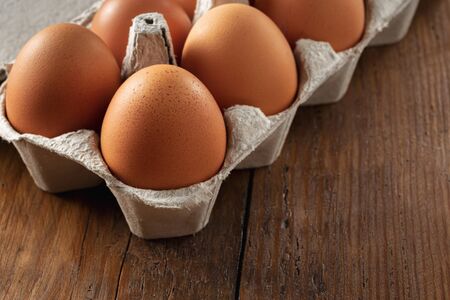 Brown eggs in a cardboard tray close upの写真素材