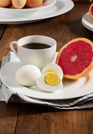 Boiled egg diet concept. Ð¡ooked eggs with grapefruit and a cup of black coffeeの写真素材