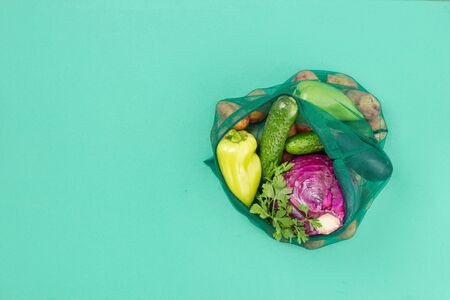 No plastic bag concept. Mesh grocery bag of assorted vegetables. Top view. Flat layの写真素材