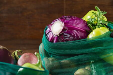 No plastic bag concept. Mesh bags for vegetables of healthy food on wooden tableの写真素材