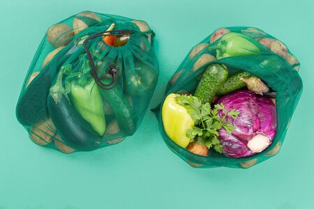 No plastic bag concept. Mesh bag of different vegetables. Top view. Flat layの写真素材