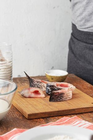 Cooking carp steaks in home kitchen. Preparing healthy and diet foodの写真素材