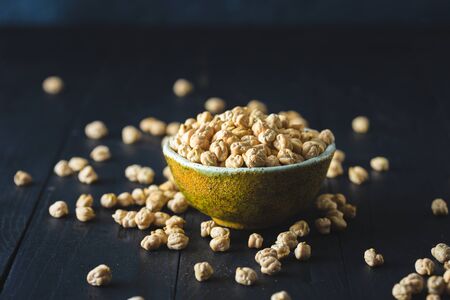 Bowl with chickpea close up on dark wooden tableの写真素材