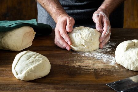 Man preparing dough for cooking homemade breadの写真素材