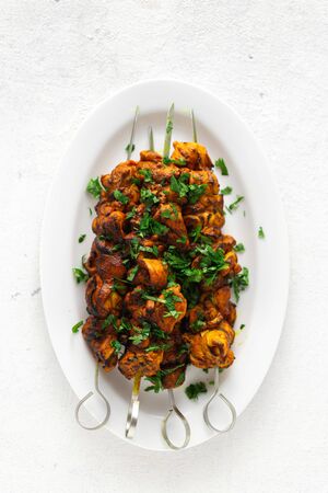 Kebab roasted  on the grill on a white plate on white background top viewの写真素材