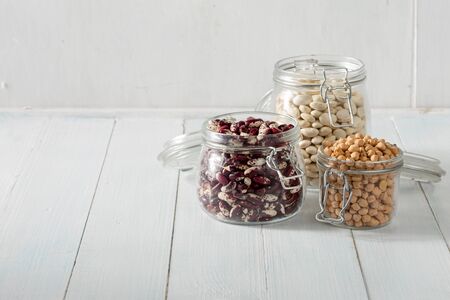 Raw grain bean in a glass jar in home kitchen. Source of protein for vegetarianの写真素材