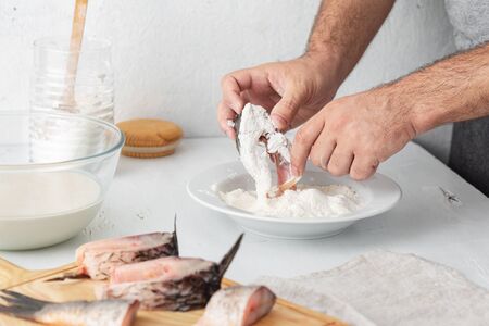 Man prepares carp river fish. Cooking healthy and diet foodの写真素材