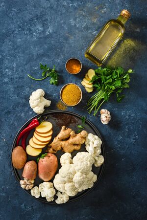 Ingredients for cooking vegetarian Indian dish aloo gobi top view. Healthy foodの写真素材