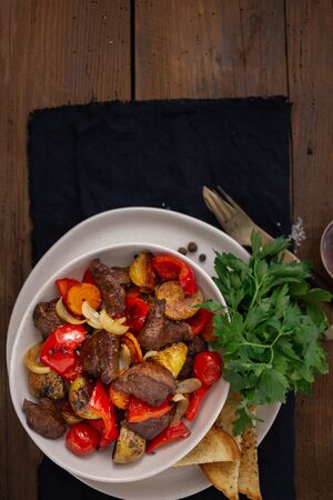 Dinner plate with fried meat and vegetables top viewの写真素材