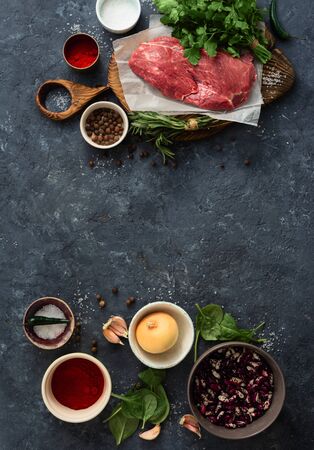 Cooking table with beef meat, vegetables, spices and herbs. Food menu conceptの写真素材