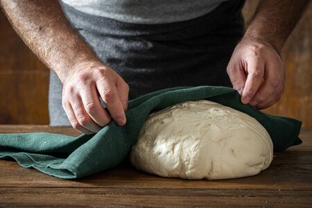 Man cooked fresh dough for baking homemade breadの写真素材