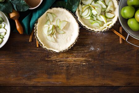 Ingredients for cooking homemade apple pie on wooden background with copy space top viewの写真素材