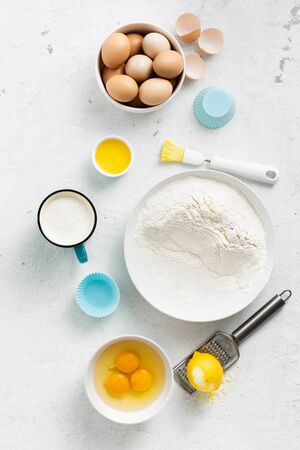 Bakery background. Baking ingredients for cooking homemade muffins or lemon cookies top viewの写真素材