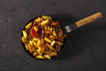 Fried potatoes with  brava sauce on a dark background top viewの写真素材