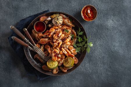 Fresh fried spiced shrimp in a frying pan top viewの写真素材