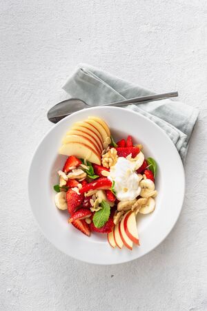 Healthy colourful summer fruit salad on a white background top view copy space. Healthy plate foodの写真素材