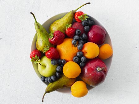 Mix fruits plate on a light background top viewの写真素材