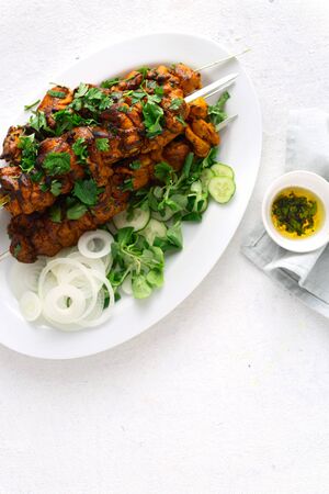 Kebab roasted  on the grill on a white plate on white background top viewの写真素材