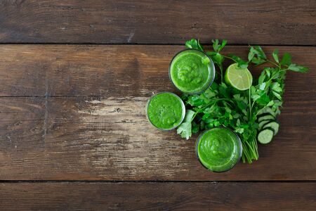 Detox diet concept. Green smoothie on a woodenの写真素材