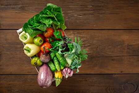 Harvesting concept. Wooden box with a bunch of different vegetablesの写真素材