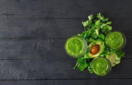 Green detox smoothie on a dark wooden  top viewの写真素材