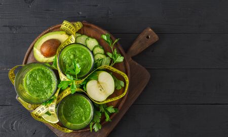 Green detox smoothie with measuring tape detox top view diet conceptの写真素材