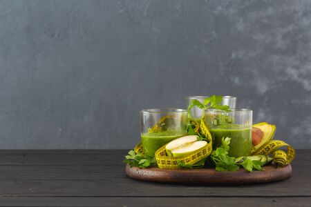 Green detox smoothie with measuring tape detox diet conceptの写真素材