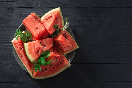 Slices of juicy ripe watermelon on a wooden  top viewの写真素材