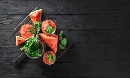 Cocktails drinks watermelon mojito on a dark wooden  with copy space top viewの写真素材