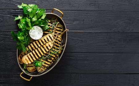 Grilled eggplant in a pan on dark wooden  with copy spaceの写真素材