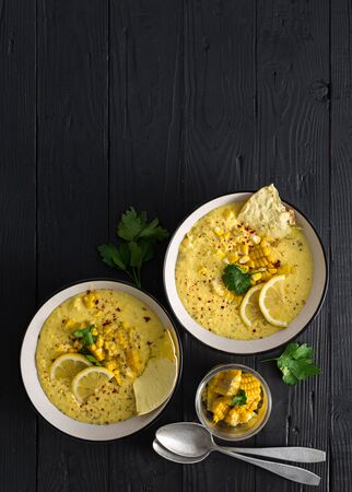 Fresh corn cream soup on a darkの写真素材