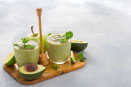 Healthy clean eating concept Fruit green smoothie on a table with copy spaceの写真素材