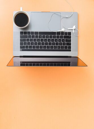 Remote work concept Laptop with cup of coffee and and headphonesの写真素材