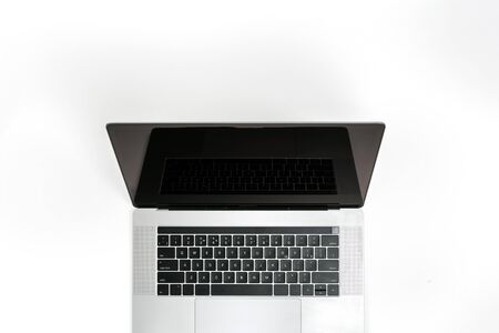 Open laptop with blank screen on a white background top viewの写真素材
